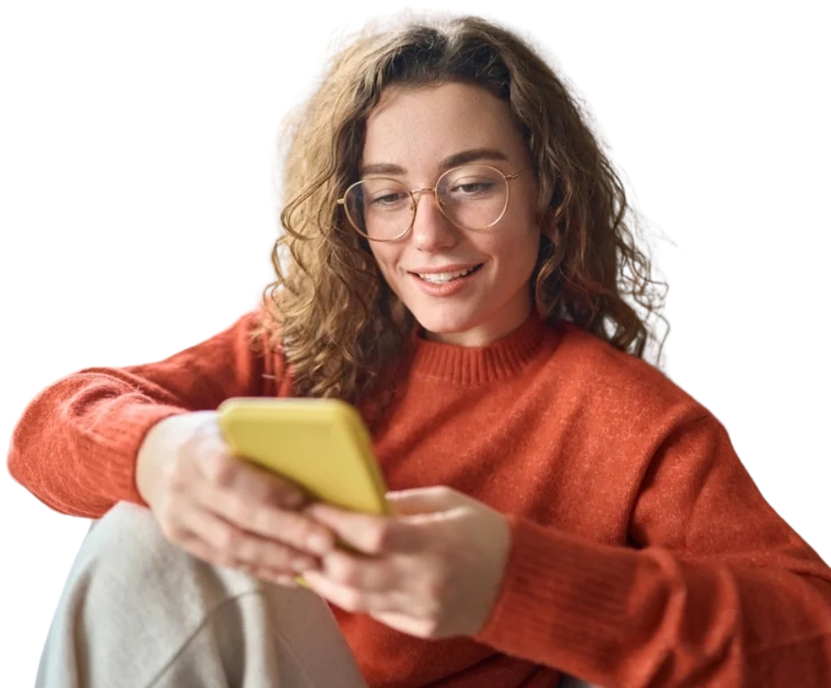 women in a sweatshirt looking at her phone